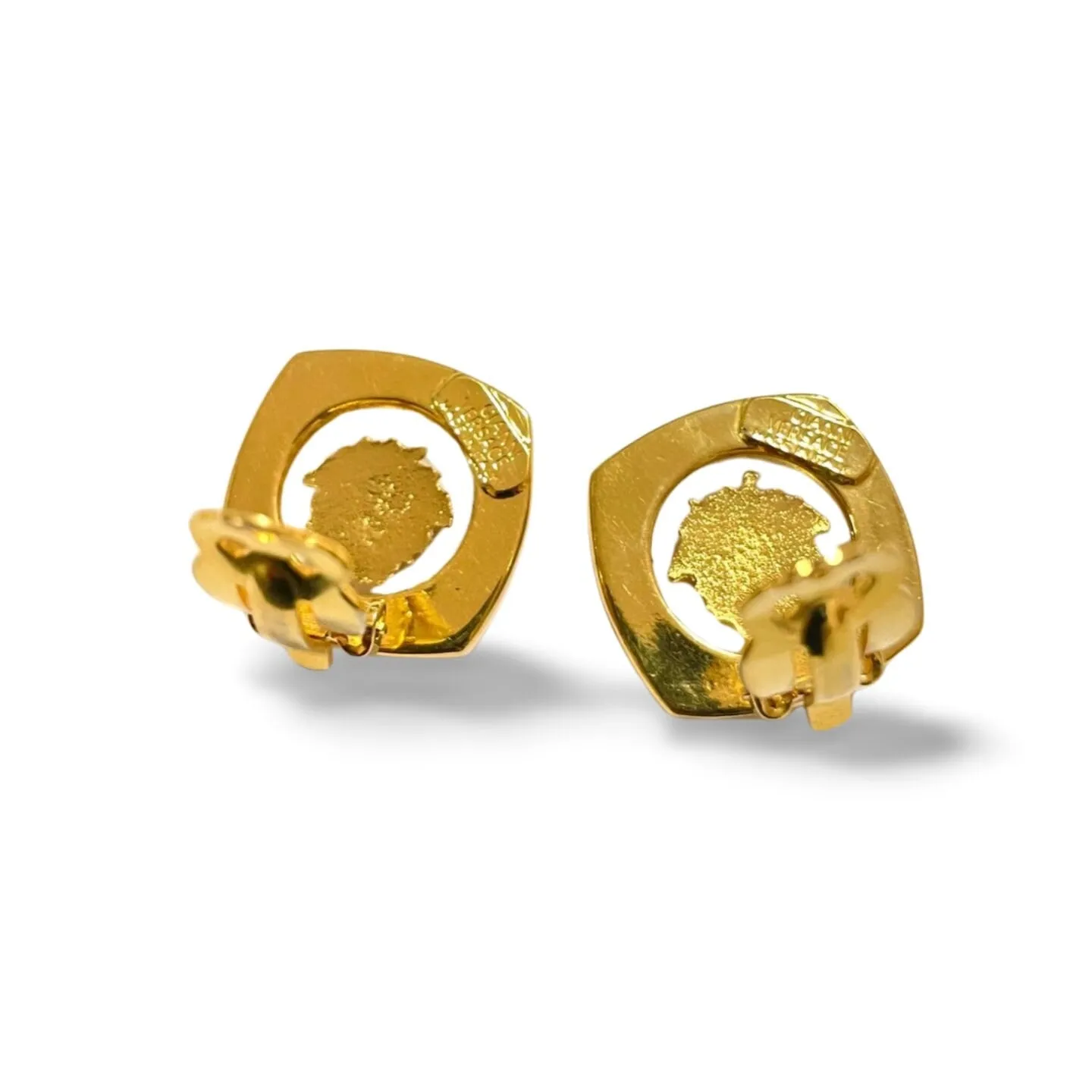 Vintage Gianni Versace clear and gold tone medusa face motif earrings. Classic jewelry. 060305m